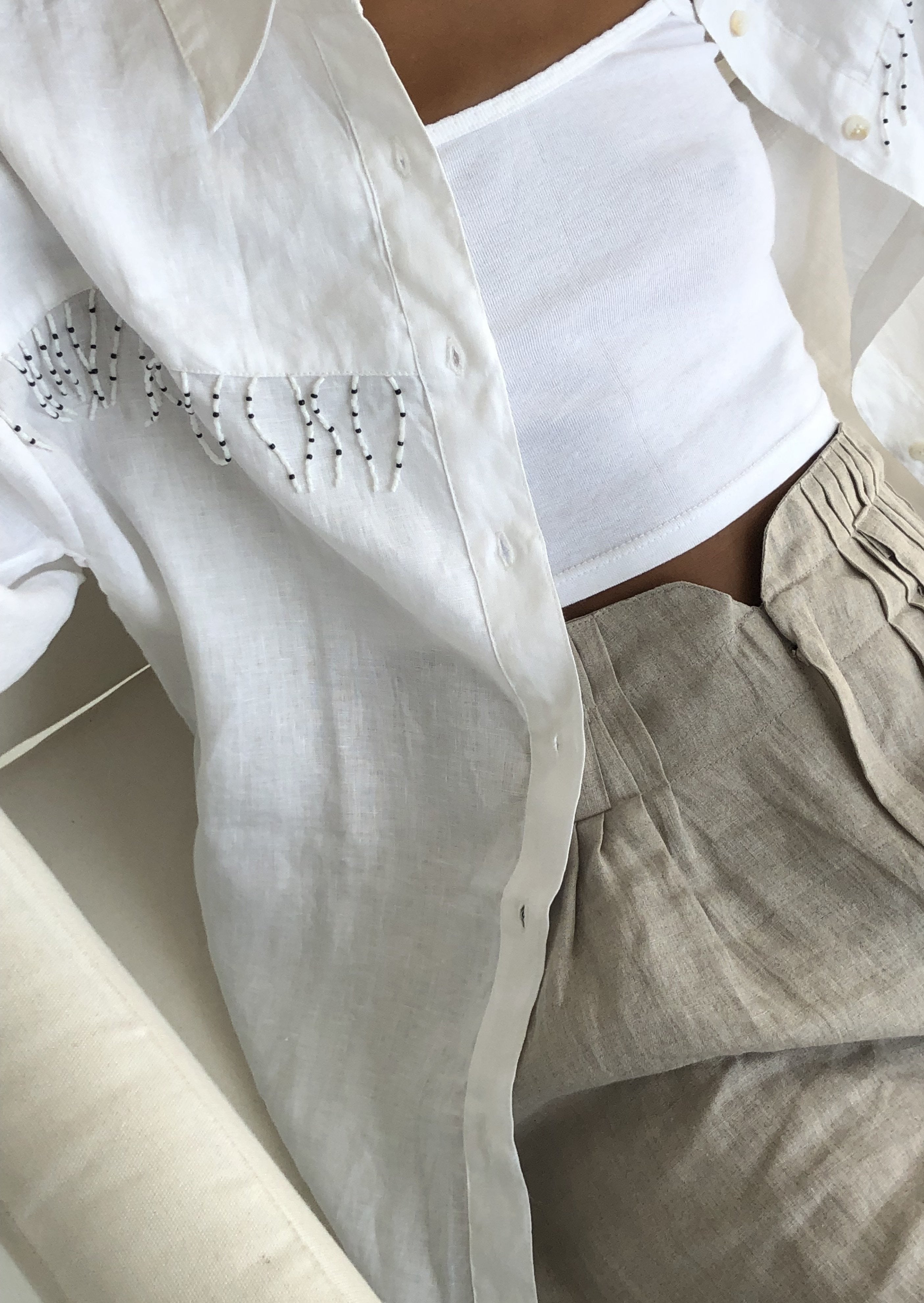 Casual Aspen outfit inspo — white fringed western linen shirt by Puka The Label, perfect for spring ski town weekends and elevated ranch-to-resort style