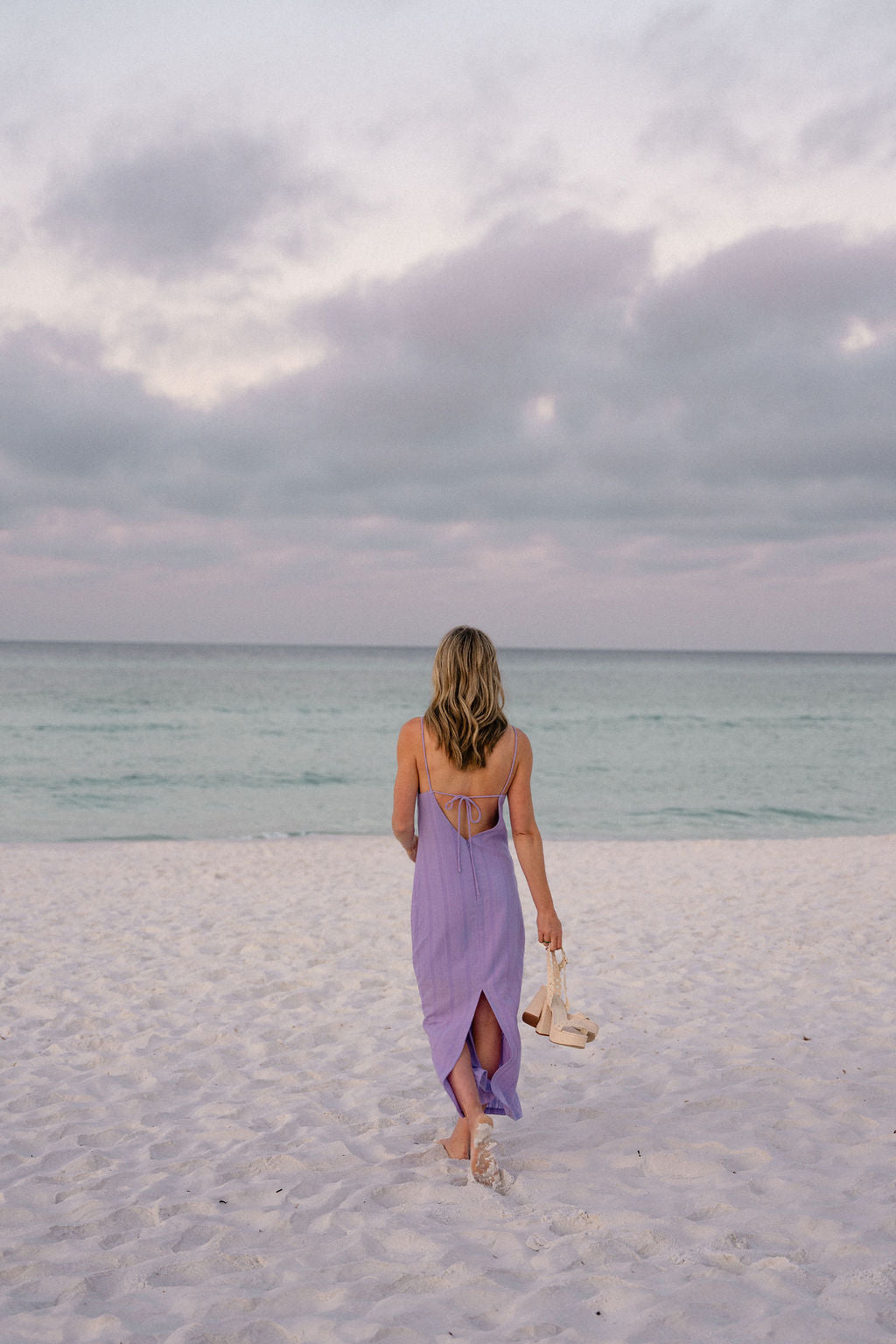 Full back view of purple Charli Dress — open back and side slit walking toward the ocean, Georgia or Florida beach outfit