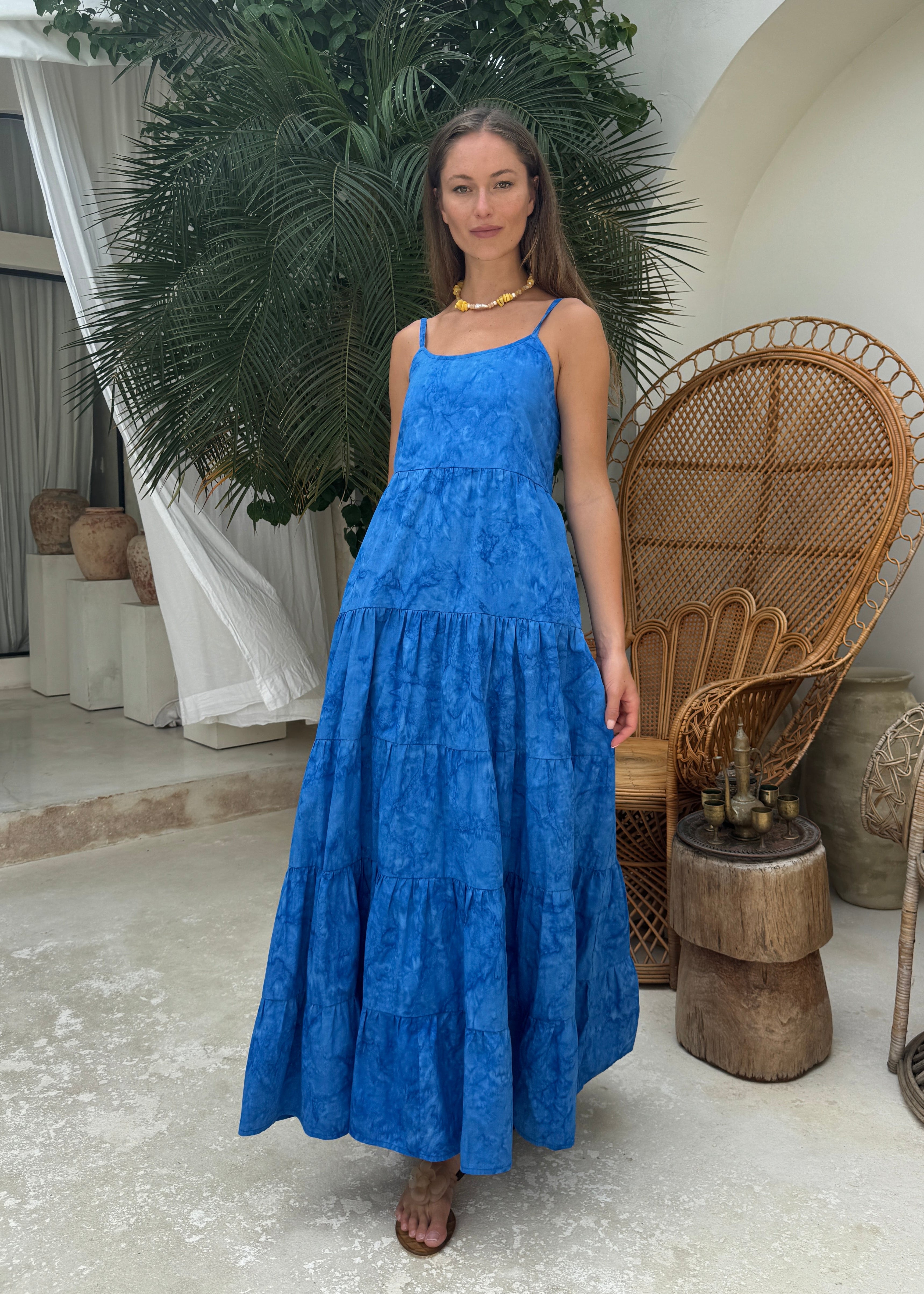 Cobalt blue tiered maxi dress black tie optional summer party outfit 2026, vibrant hand-dyed cotton dress for rooftop celebration and outdoor gala