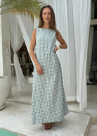 Close-up of green gingham cotton fabric, lightweight breathable check print maxi dress perfect for summer vacation Puka The Label