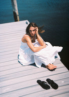 Hannah Lovey white Waverly Dress out east summer styling outfit 2026, tiered cotton maxi dress for Hamptons coastal occasion Puka The Label