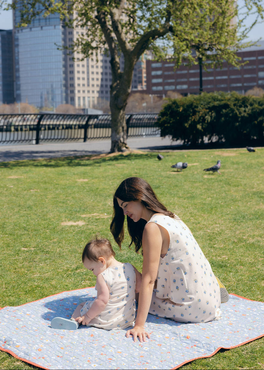 Blue Posey Little Gili girls spring picnic dress, mom and baby in matching blue floral cotton dresses on blanket outdoors Puka The Label