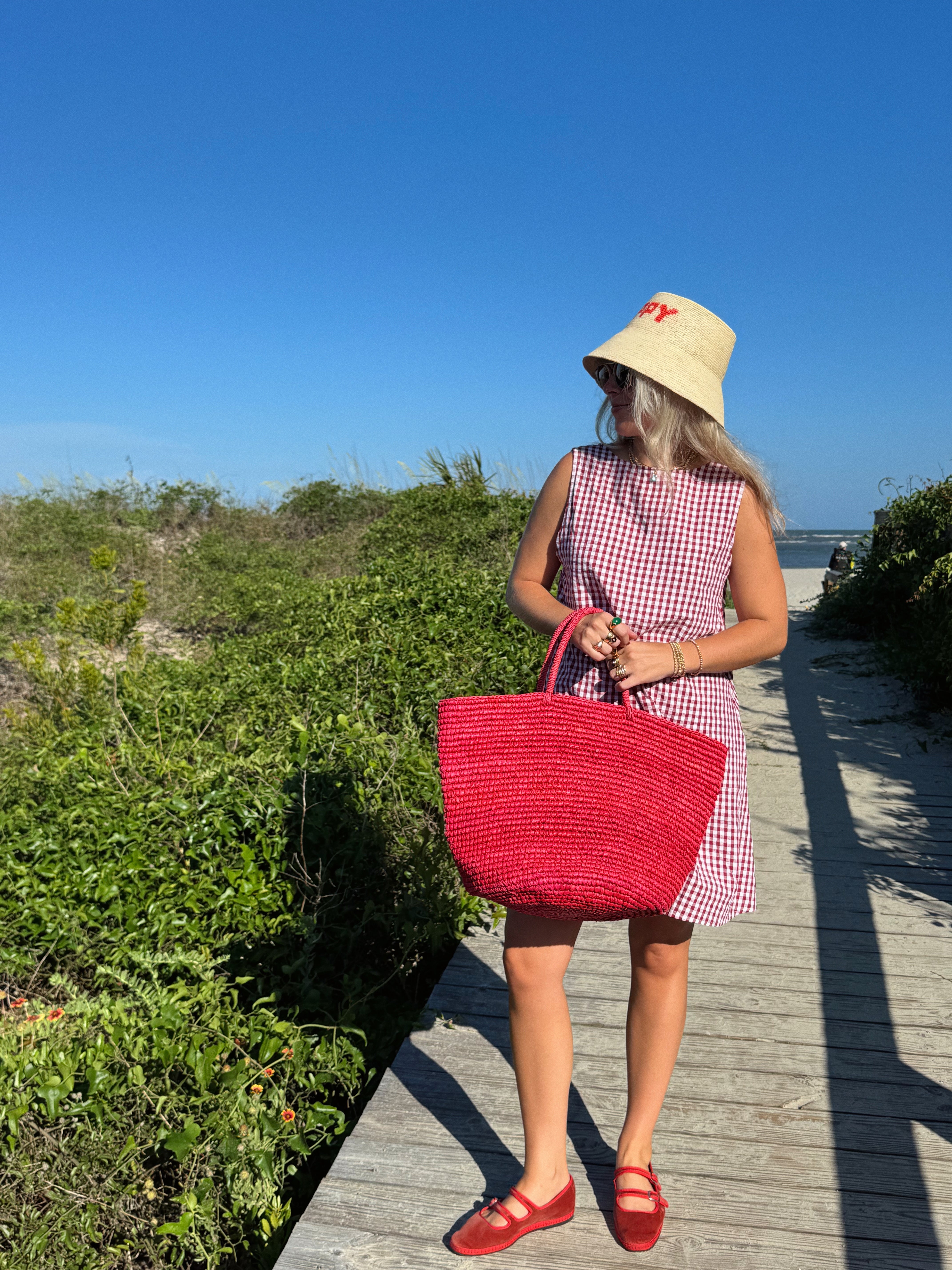 influencer meredith wyche wears a cute short red gingham dress in the summer in SC