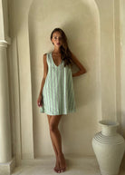 Mini Gili aquamarine green stripe ghost mannequin flat lay, vibrant preppy hemp organic cotton reversible mini dress 55% hemp 45% organic cotton Puka The Label 2026