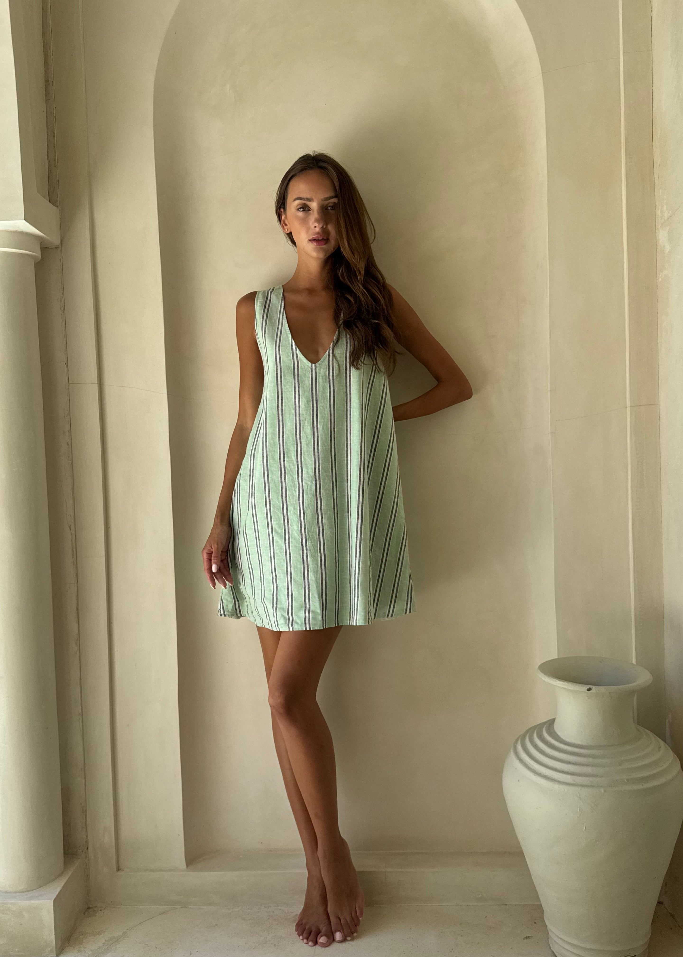 Mini Gili aquamarine green stripe ghost mannequin flat lay, vibrant preppy hemp organic cotton reversible mini dress 55% hemp 45% organic cotton Puka The Label 2026