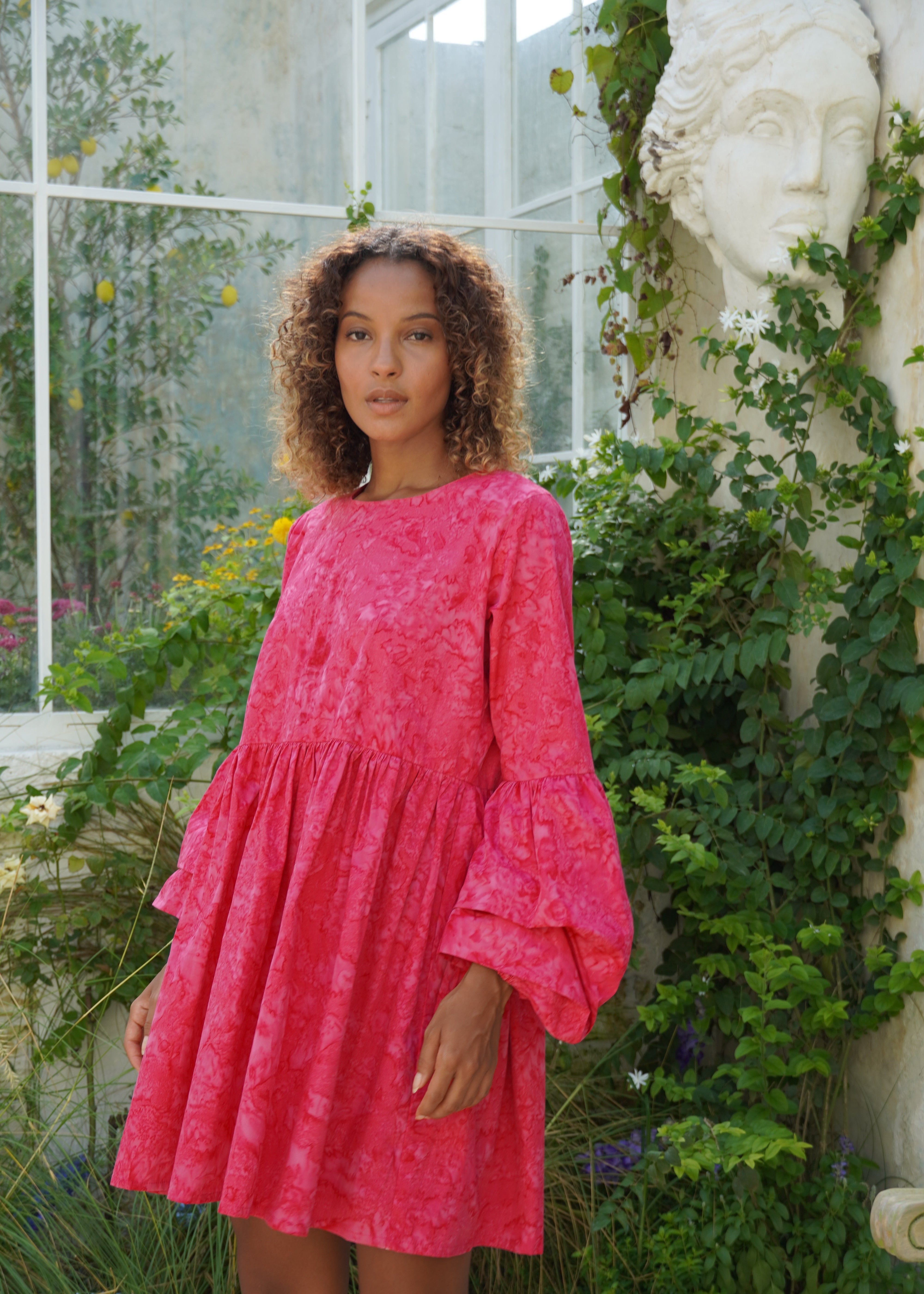 Pink hand-dyed oversized cotton mini dress beach vacation outfit summer 2026, effortless ruffle sleeve dress for warm weather travel and resort getaway