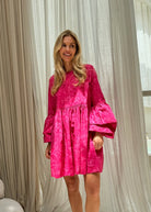 Pink hand-dyed ruffle sleeve Nori Dress bachelorette party and girls weekend outfit 2026, vibrant cotton mini dress for fun summer celebration