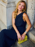 Full-length front view of the Puka Camilla Dress in Midnight at NYC flower shop, flat sandals