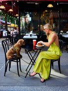 Natalie Simkins in the Puka Carlyle Set Olive Brine at Bar 91 NYC cafe — front view halter top and wide-leg pants