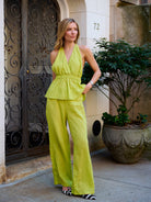 Full-length front view of the Puka Carlyle Set in Olive Brine at NYC townhouse entrance, zebra kitten heels