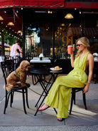 Full view of Puka Carlyle Set Olive Brine at Bar 91 Upper East Side NYC, Natalie seated at cafe