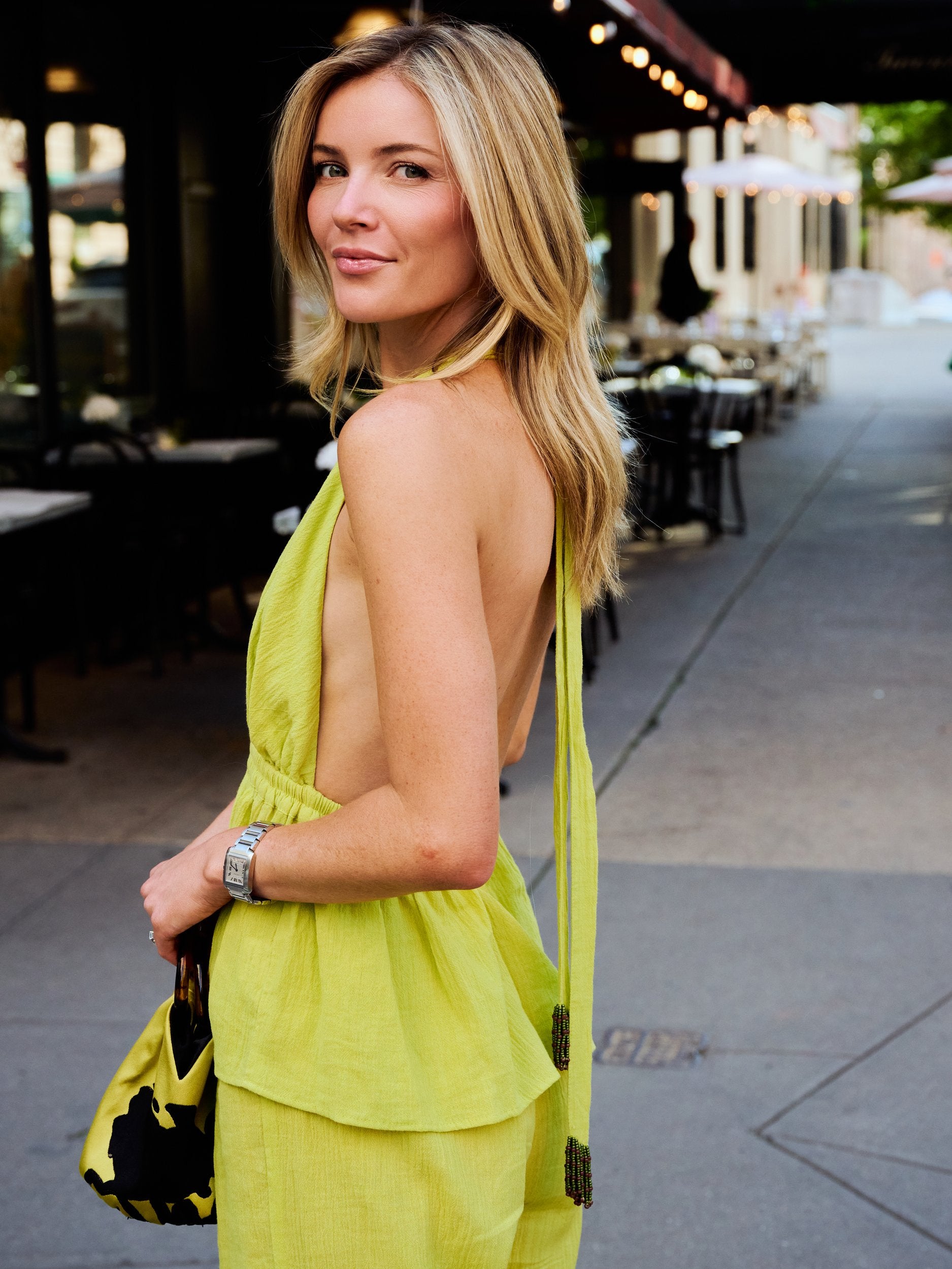 Close-up back detail of Carlyle halter top Olive Brine showing beaded tassel neck tie, NYC sidewalk