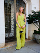 Natalie Simkins in the Puka Carlyle Set Olive Brine, front view at NYC townhouse, styled with floral mini bag