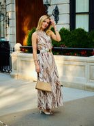Natalie Simkins in the Cleo maxi dress Brown Zebra print, lush garden background