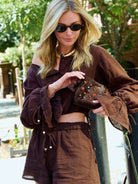 Full body view of the Colette Set Espresso on NYC street — wide balloon sleeves and high-waist shorts