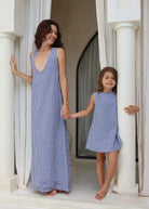 Woman and child in matching blue gingham dresses celebrating Mother's Day 