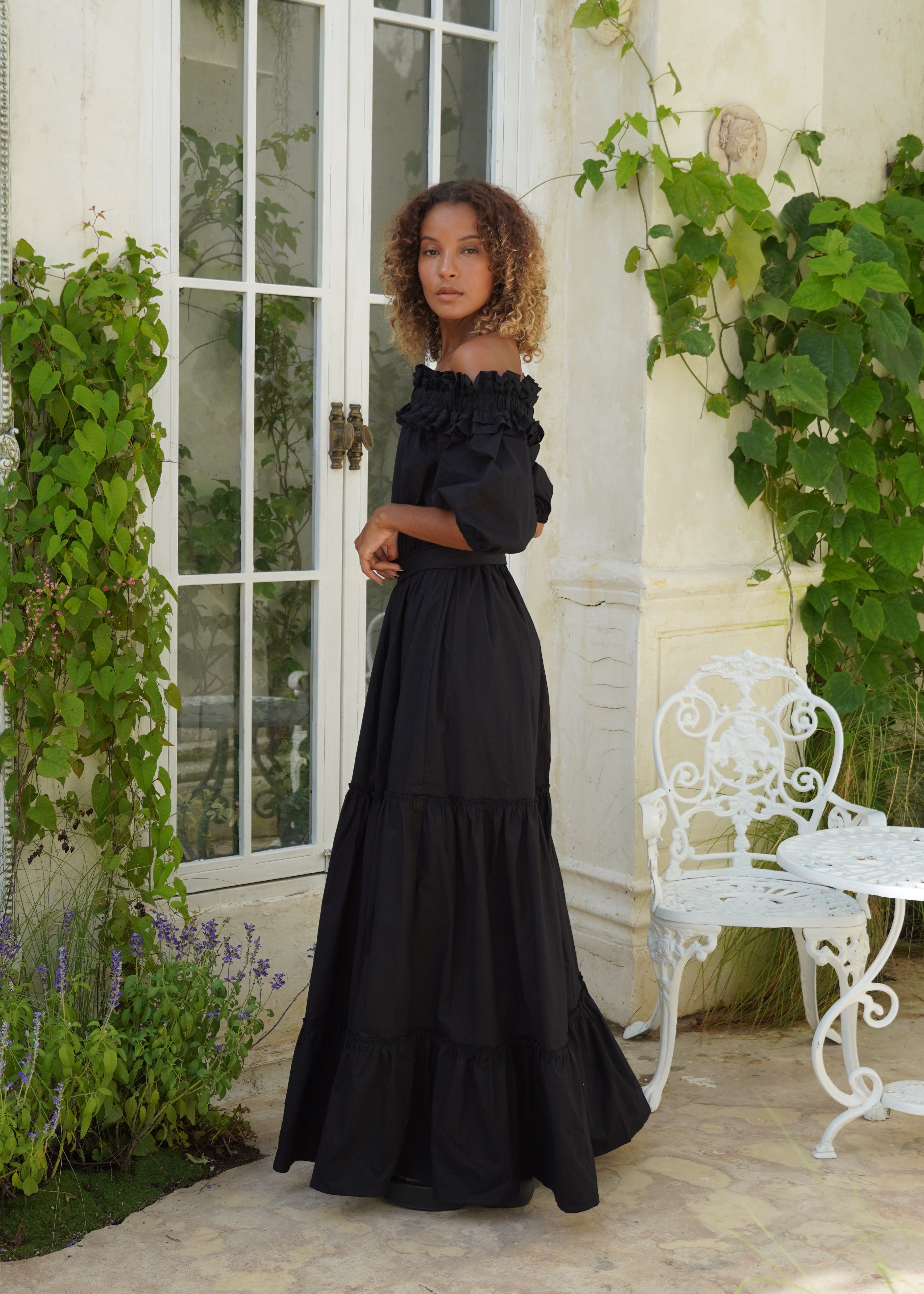 Ruffled off the shoulder black dress coastal evening outfit idea, dramatic flowy maxi dress for beach weddings and parties