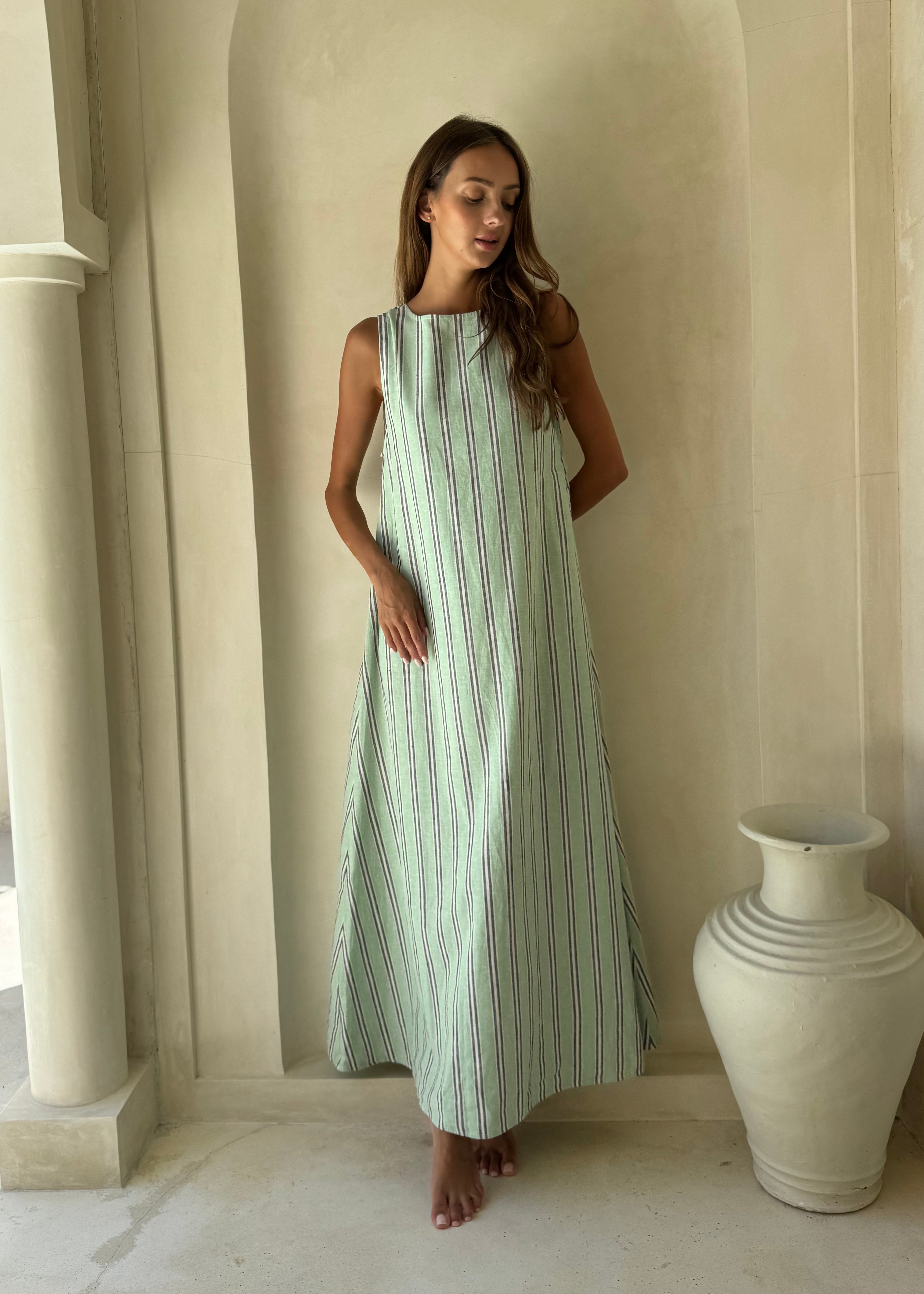 Gili Green Navy and White Stripe Maxi Dress worn in a Santorini-inspired setting, perfect summer travel dress