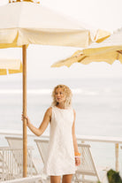 White floral eyelet mini dress bachelorette trip and beach destination outfit 2026, elegant cotton Mini Gili dress for coastal girls weekend celebration