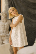 White floral eyelet cotton mini dress beach vacation spring outfit 2026, reversible V-neck or high neck Mini Gili dress Puka The Label