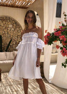 White ruffle mini dress in linen — off-shoulder women's dress perfect for beach wedding guest outfits and bridal shower attire
